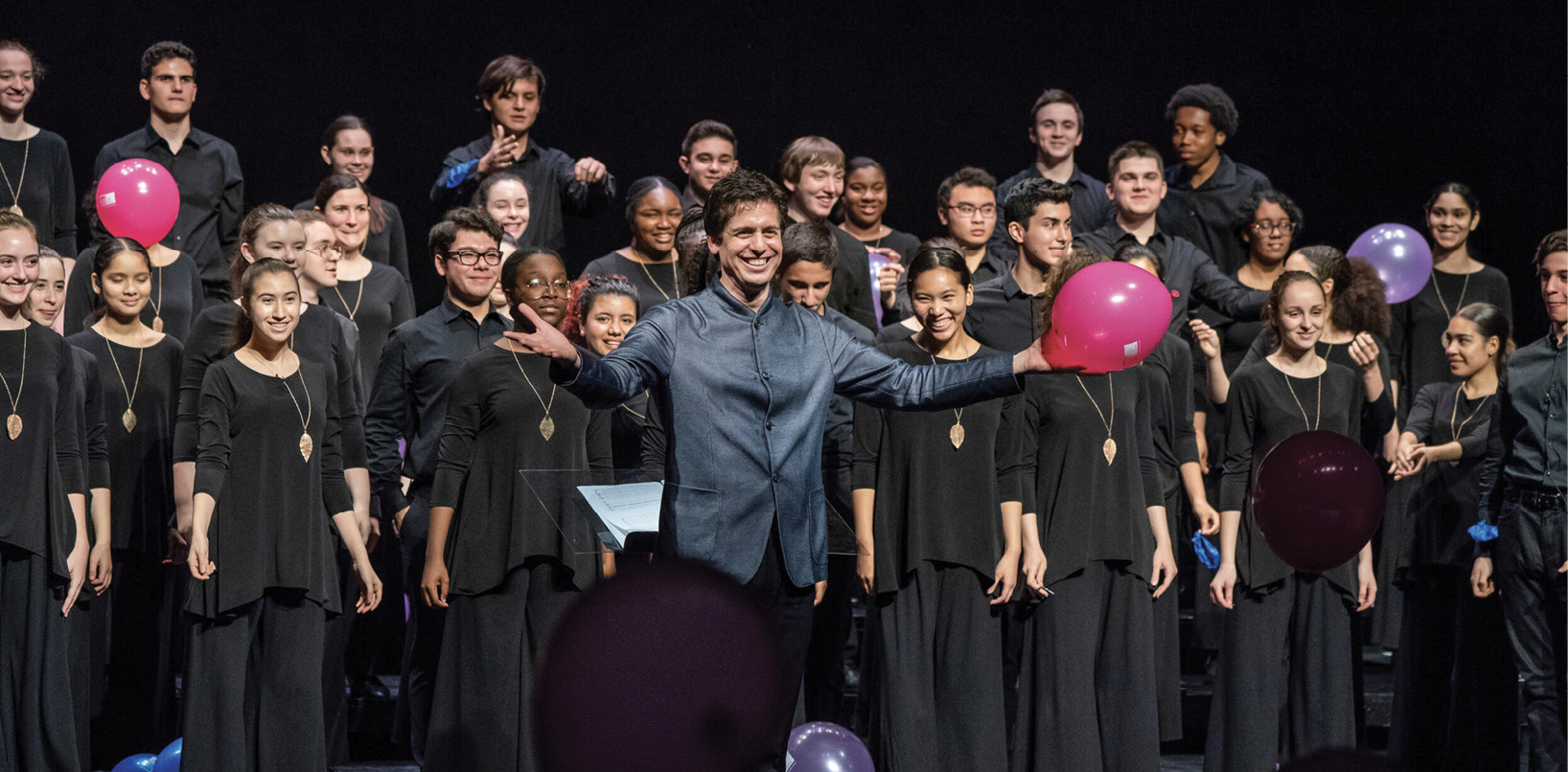 Choir director standing in front of kids choir.